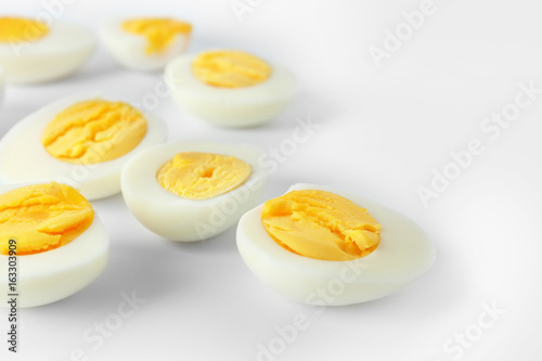 Sliced hard boiled eggs on white background. Nutrition concept