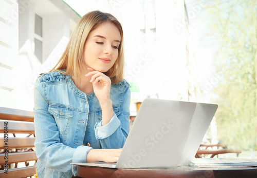 Young girl sitting on bench...