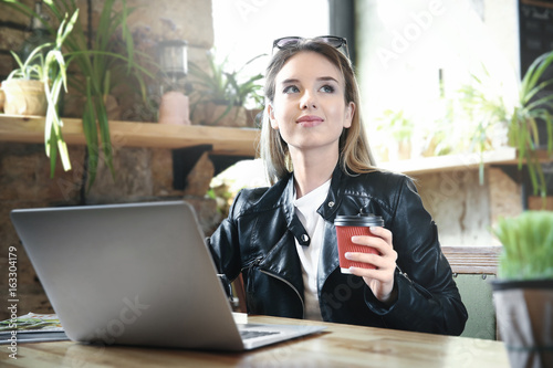 Young girl holding cup of c...