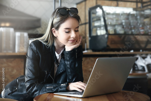 Young girl using laptop in ...