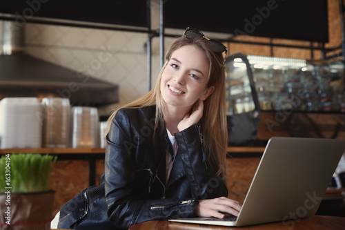 Young girl using laptop in ...