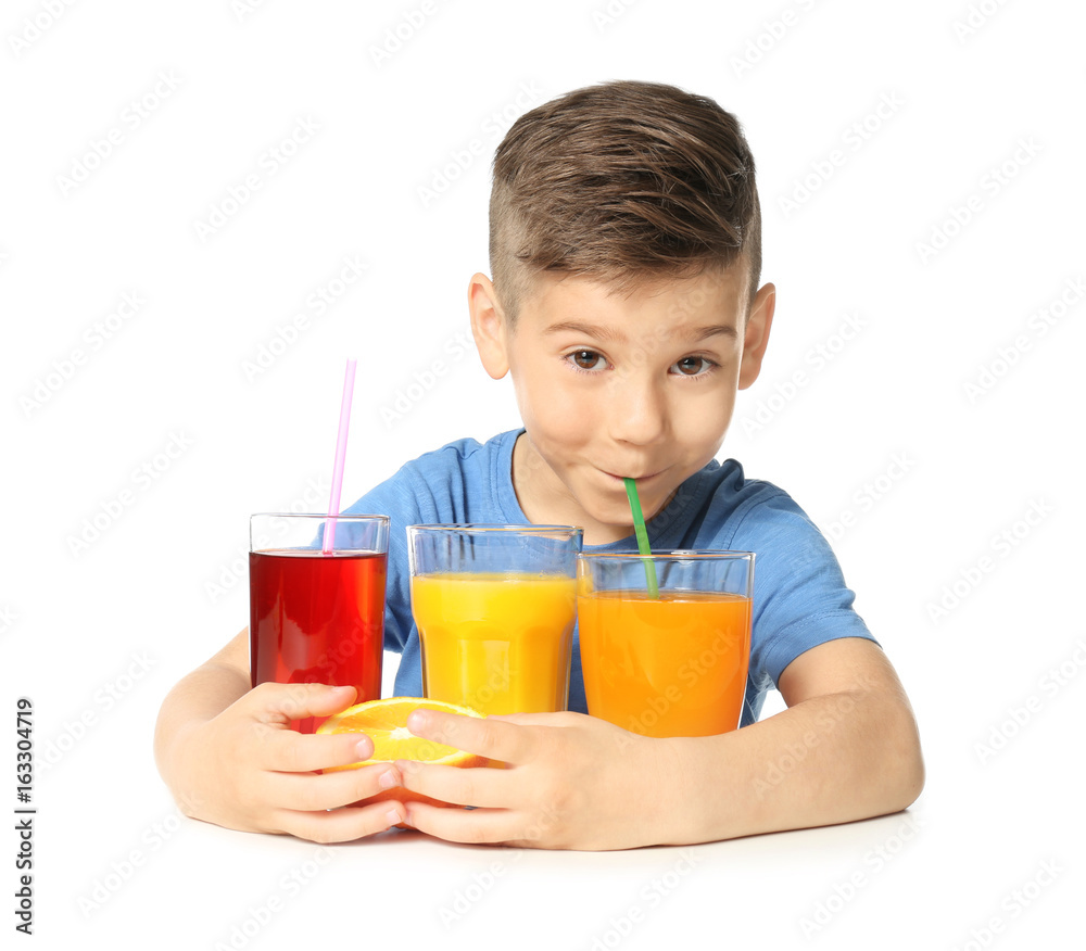 Cute little boy with glasses of different juice on white background Cute little boy with glasses of different juice on white background