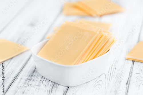 Sliced Cheese (selective focus) on vintage wooden background