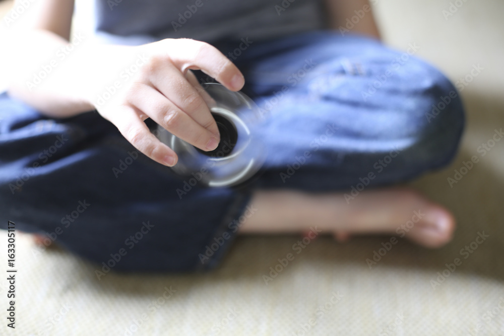 Little Boy Playing with a Fidget Spinner Little Boy Playing with a Fidget Spinner