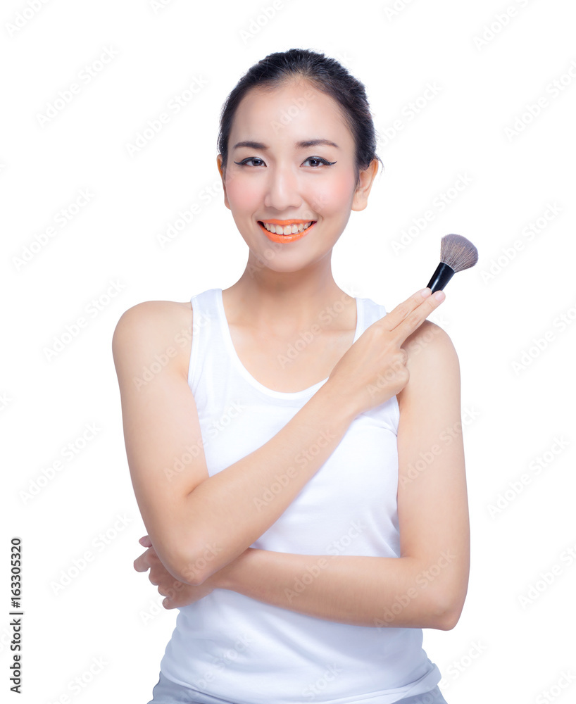 Portrait of the beautiful woman with makeup brushes near face Portrait of the beautiful woman with makeup brushes near face