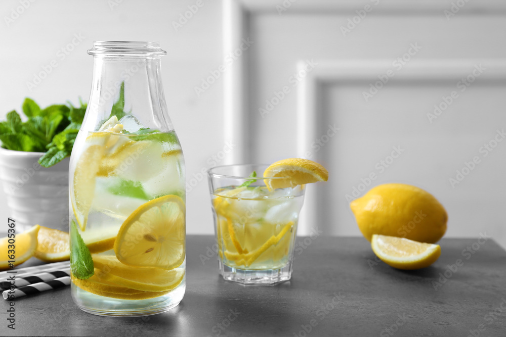 Bottle and glass of fresh lemonade on grunge table Bottle and glass of fresh lemonade on grunge table