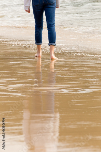 Solitary person walking - wading in incoming waves © CreativeFire