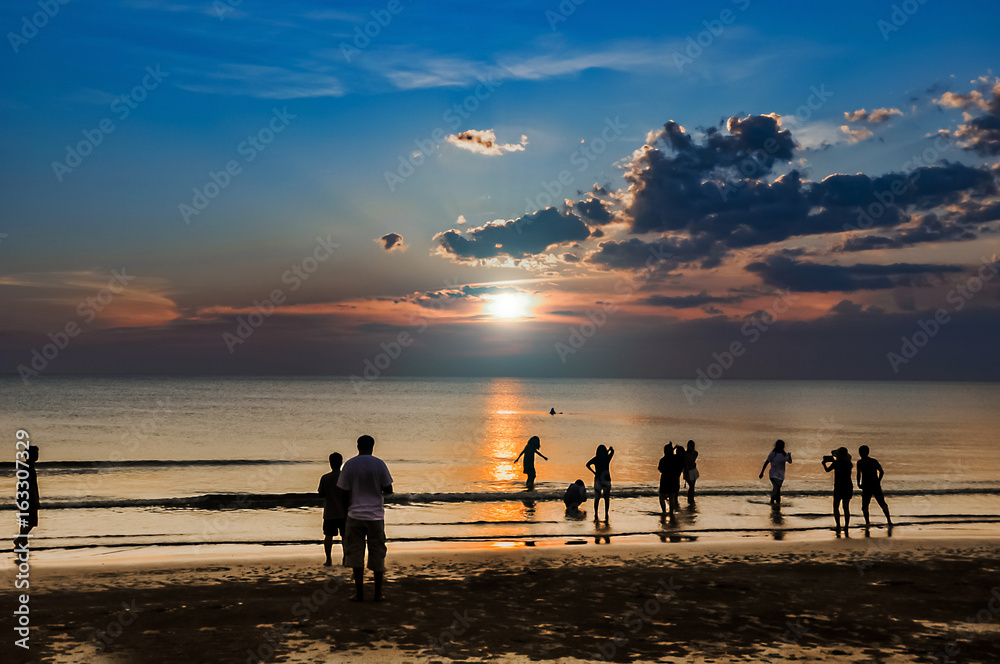 Fototapeta premium people on the beach at the sunset time.friendly and family on the beach concept.