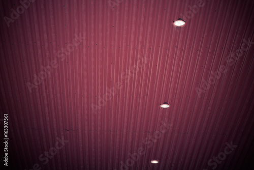 Red maetal background with three lights