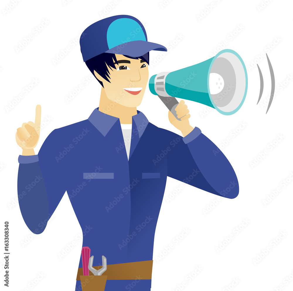 Young asian mechanic talking into loudspeaker. Young asian mechanic talking into loudspeaker.