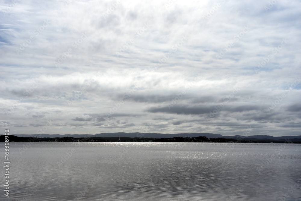 Dramatic sky with large clouds over lake Macquarie (Swansea Central Coast NSW Australia).