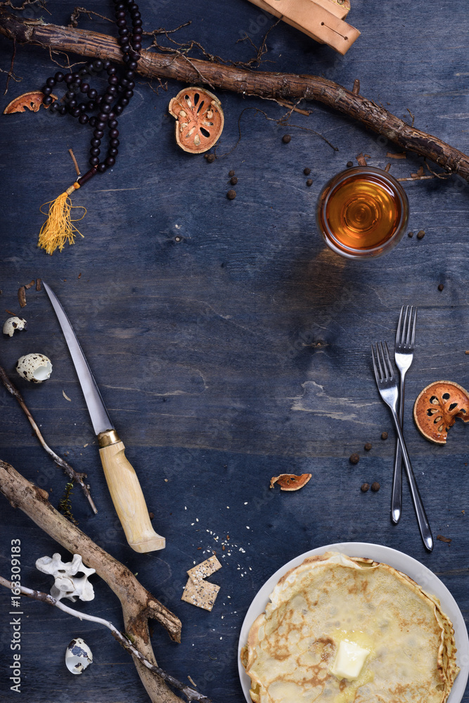 Naklejka premium Breakfast table with pancakes and juice, hunters hut vintage style.