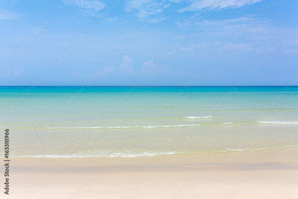 Tropical white sand beach with turquoise water under blue sky. Paradise background