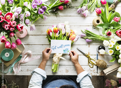 Fotografija Florist Making Fresh Flowers Bouquet Arrangement with Get Well Soon Wishing Card