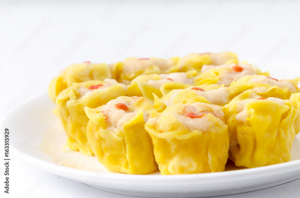 Chinese steamed shrimp dumplings on white dish