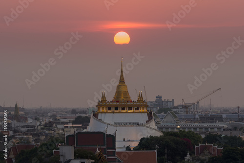 Golden Mountain with  the sun on the top at Wat Saket, Thailand © chomphunuts