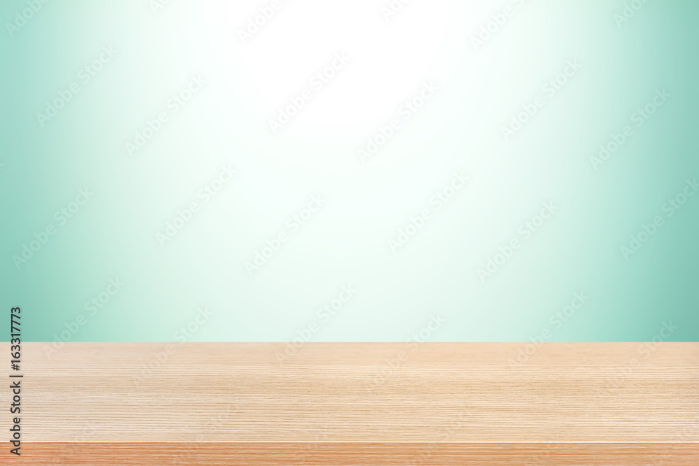 Wood table top on light green gradient background Wood table top on light green gradient background