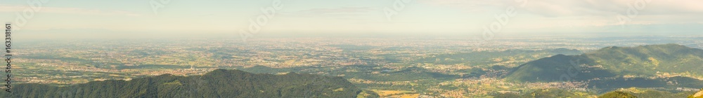 Great landscape on the Padana plain in summer time. Panorama from Linzone Mountain, Bergamo, Italy. 