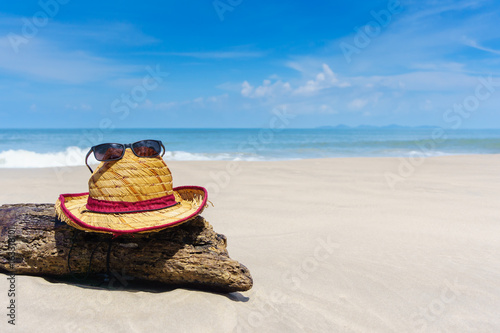 hat and sunglasses on beautiful beach