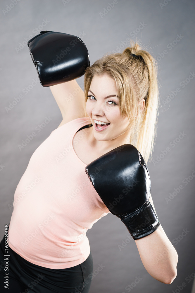 Happy smiling woman wearing boxing gloves Happy smiling woman wearing boxing gloves