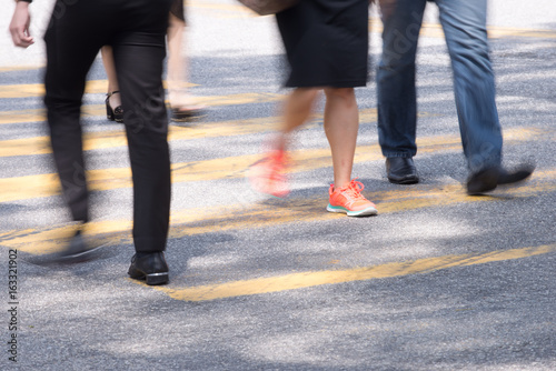 Motion Blur - People crossing the road. Blurry effect to illustrate movement
