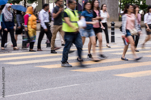 Motion Blur - People crossing the road. Blurry effect to illustrate movement