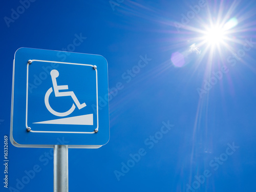 Disabled parking space and wheelchair way sign and symbols on a pole warning motorists