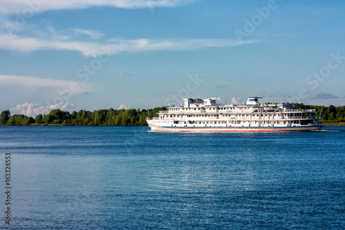 Passenger cruise ship sails on the river