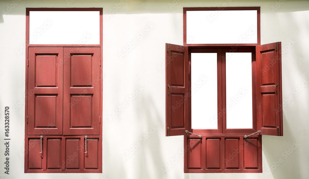 Two red wood twin windows one open one close on white wall background Two red wood twin windows one open one close on white wall background
