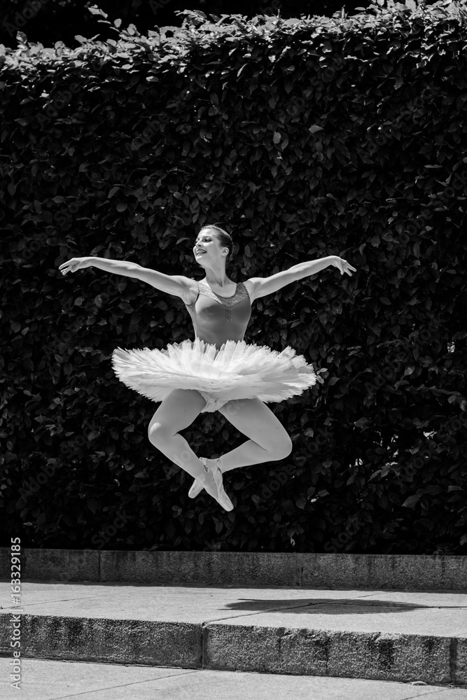A gorgeous european young woman ballet dancer in city, inspiration for other people. Looks like princess have grace and body plastic dancing on outdoors 
