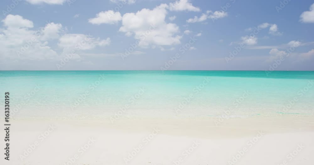 Beach background - Caribbean beach with turquoise water and white sand beach and blue sky. SLOW MOTION. RED EPIC. Beach background - Caribbean beach with turquoise water and white sand beach and blue sky. SLOW MOTION. RED EPIC.