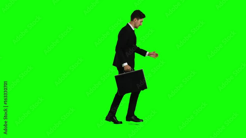 Man holds a briefcase in his hand, he rushes over it. Green screen Man holds a briefcase in his hand, he rushes over it. Green screen