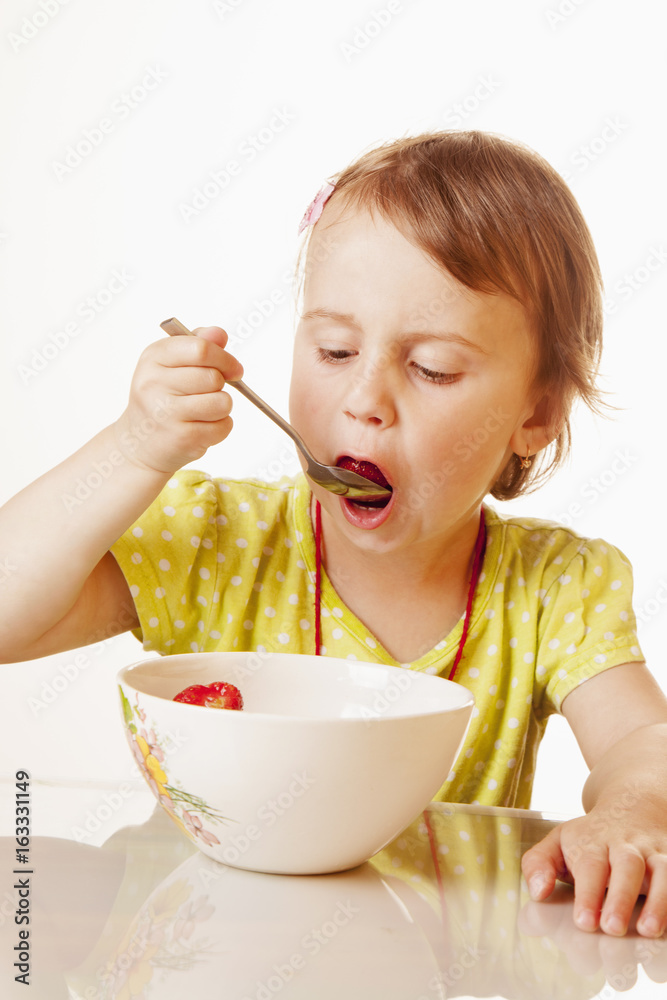 A little beautiful baby girl eating and enjoying of fresh strawberries. (Health, Nutrition, Vitamins, Happy Childhood Concept) A little beautiful baby girl eating and enjoying of fresh strawberries. (Health, Nutrition, Vitamins, Happy Childhood Concept)