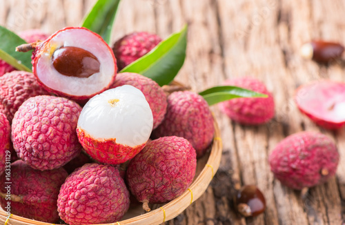 fresh organic lychee fruit on bamboo basket photo