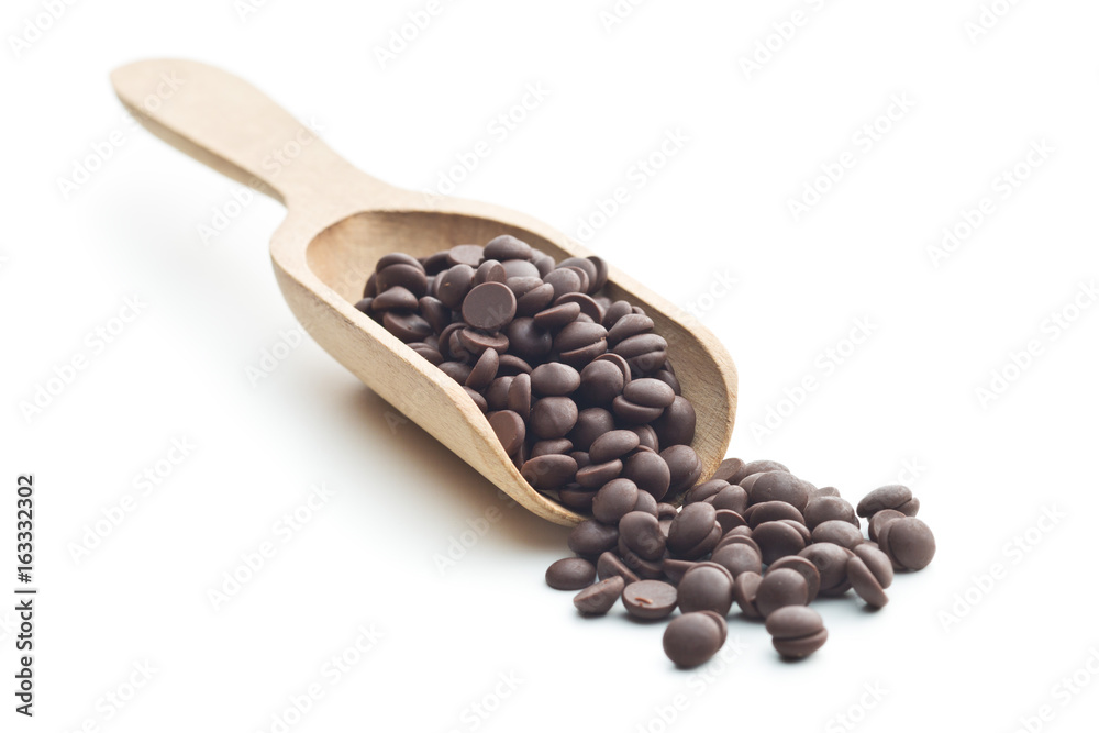 Fototapeta premium Tasty chocolate morsels in wooden scoop.
