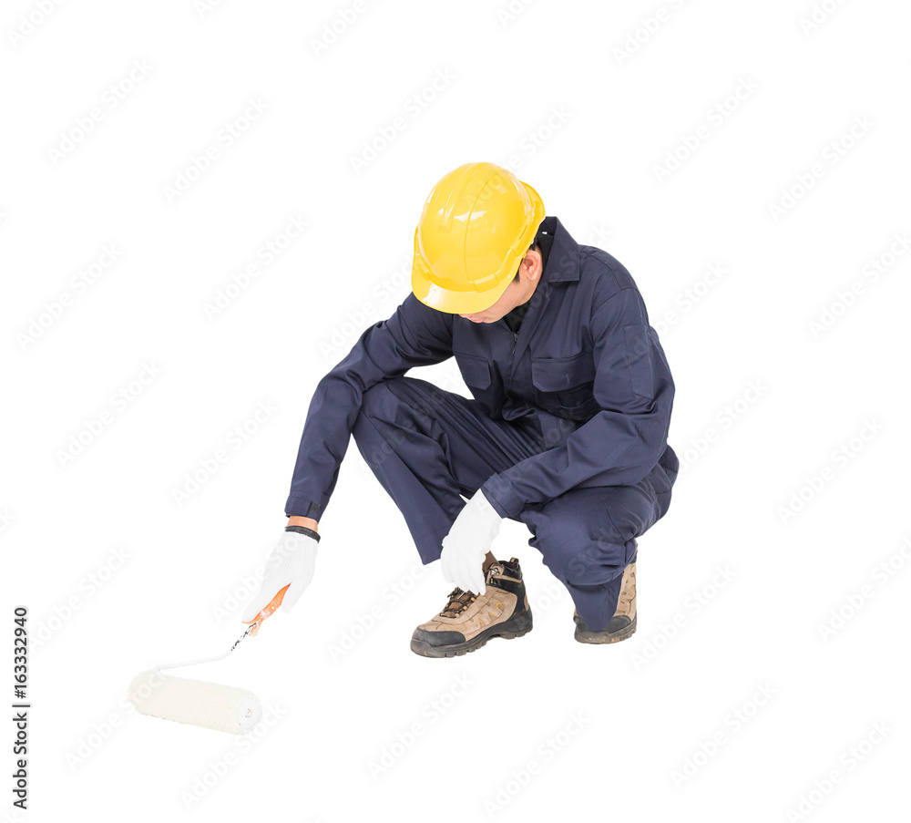 Worker in a uniform using a paint roller is painting invisible floor Worker in a uniform using a paint roller is painting invisible floor