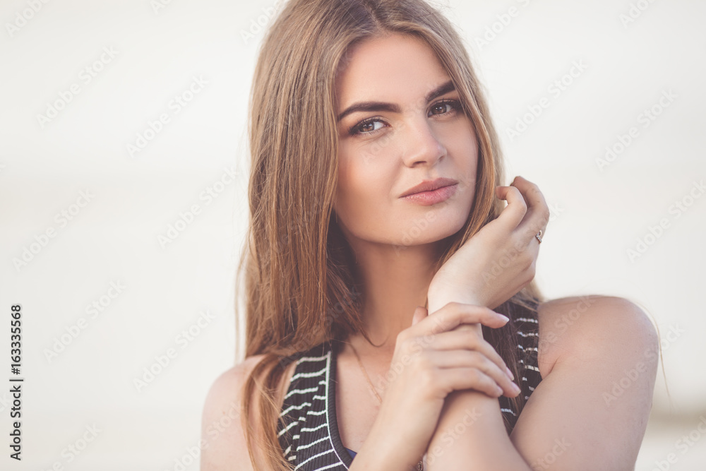 Portrait of pretty young teen girl over white wall background
