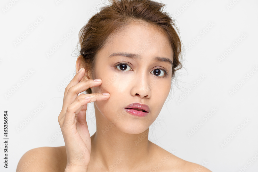 young woman worrying about her skin. beauty and skincare concept. young woman worrying about her skin. beauty and skincare concept.