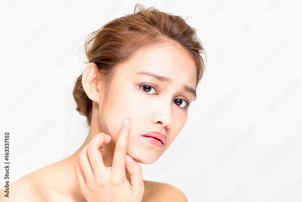 Fototapeta premium young woman worrying about her skin. beauty and skincare concept.