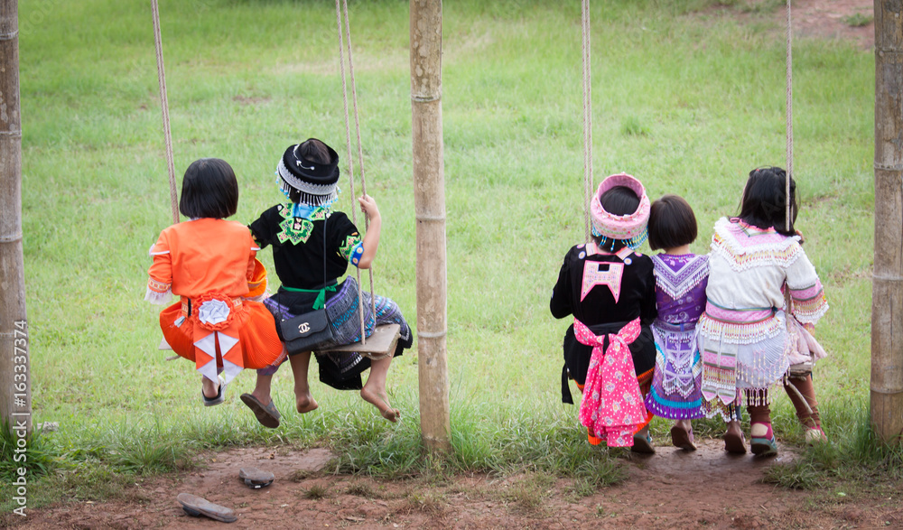 Fototapeta premium Hill tribe children playing swing