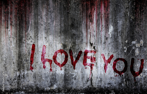 Write a message I love you on bloody background scary old wall, concept of disappointed in love and horror