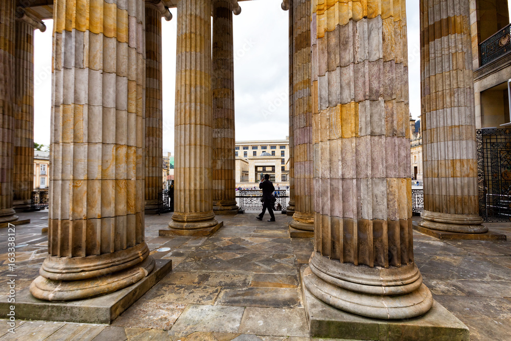 BOGOTA, COLOMBIA - JUNE 14: An unidentified man walks between the pillars at the Capitolio Nacional in Bogota, Colombia on June 14, 2016.