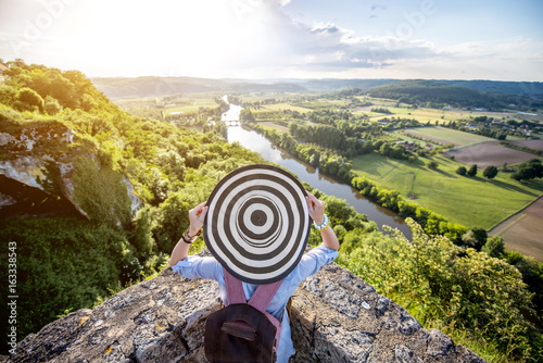 Konstfotografi Young woman tourist in hat enjoying sunset view on the beautiful landscape with