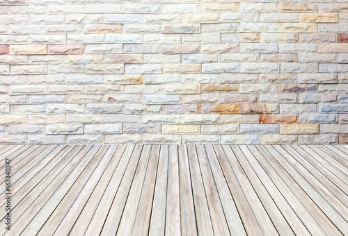 empty room with stone wall and wooden floor.