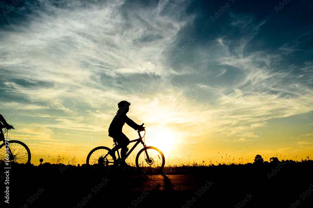 Silhouette of cyclist riding on bike at sunset. Silhouette of cyclist riding on bike at sunset.