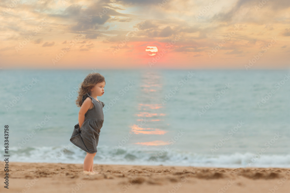 Little girl on the beach at sunset. Summer, ocean, paradise. Outdoor.