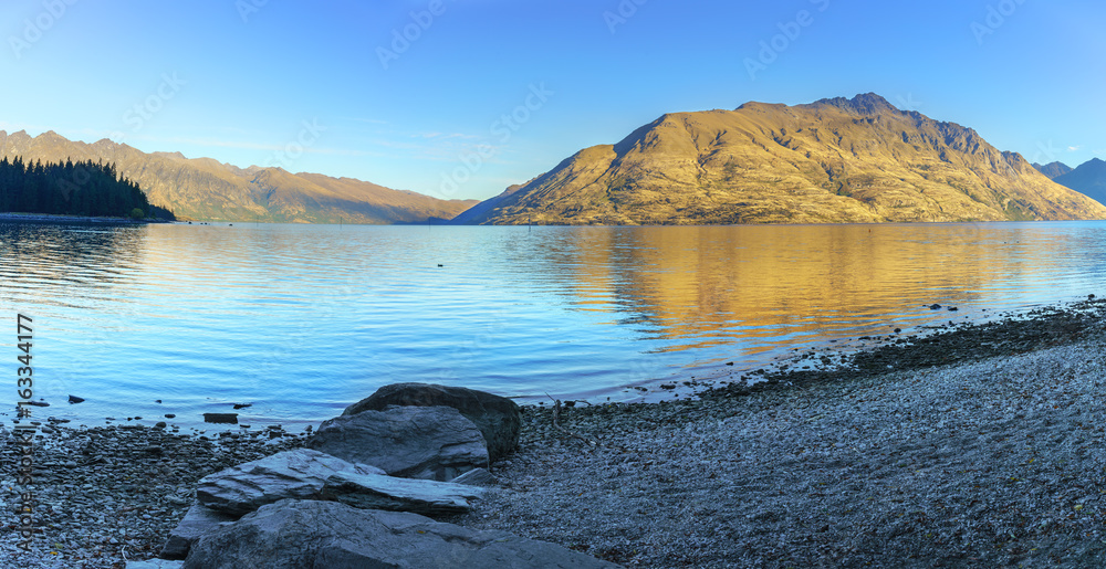 Panoramic serenity of beautiful Lake Wakatipu in the morning in Autumn , Queenstown , South Island of New Zealand