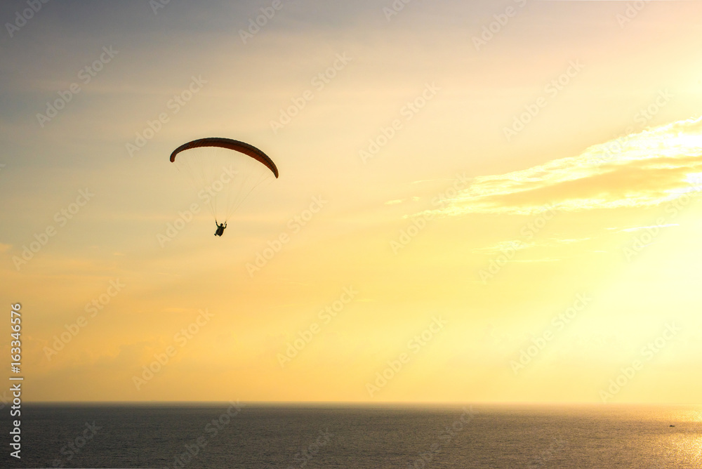 Silhouette of paraglider soaring over sea at sunset,Phuket,Thailand. Silhouette of paraglider soaring over sea at sunset,Phuket,Thailand.