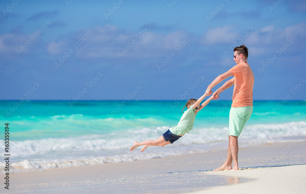 Family beach activity. Father and daughter together have fun Family beach activity. Father and daughter together have fun