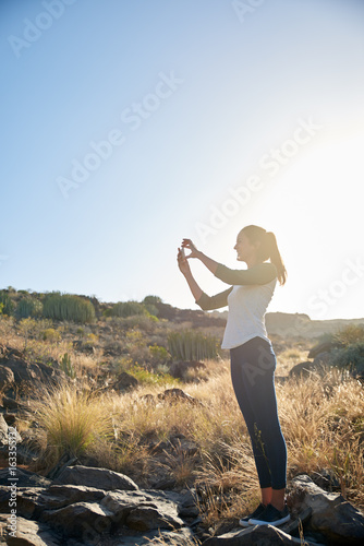Lovely young woman taking a photo © pablocalvog